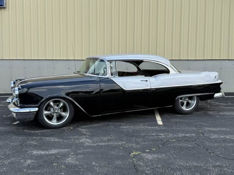1955 Pontiac Chieftain, driver side profile showing the two-tone paint and polished five-spoke wheels