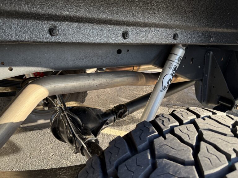 1983 Chevrolet K20 Silverado 4x4, undercarriage showing Fox 2.0 shock, rear axle and exhaust