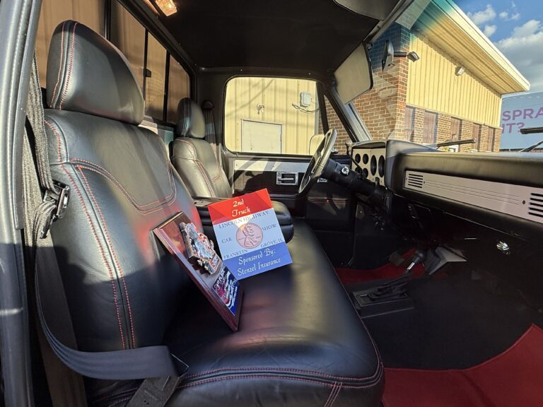 1983 Chevrolet K20 Silverado 4x4, cab interior with car show awards on the bench seat