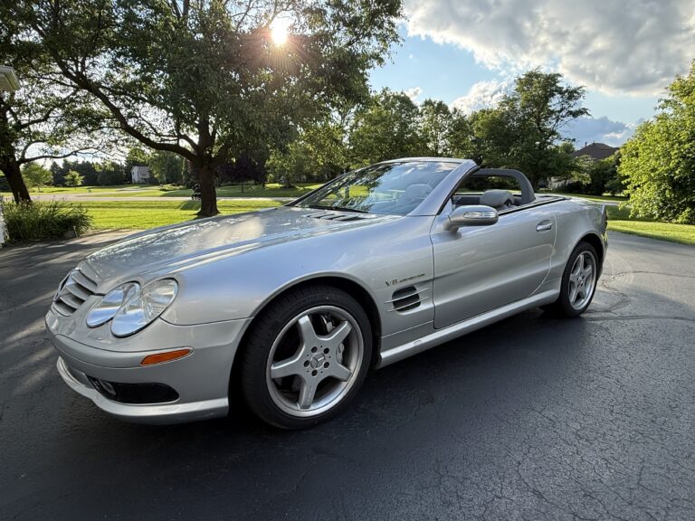 2004 Mercedes-Benz SL55 AMG, low front three-quarter view showing the AMG front fascia and five-spoke wheels