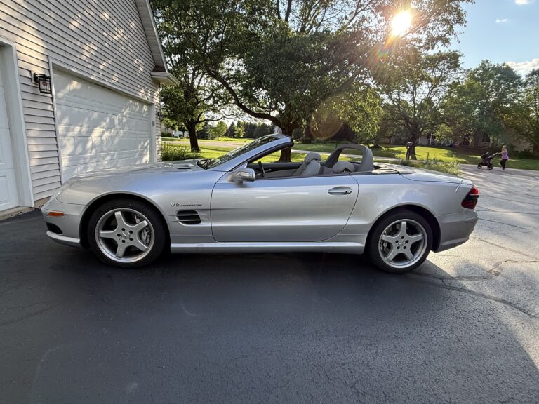 2004 Mercedes-Benz SL55 AMG, driver-side profile with the top down and V8 Kompressor fender badge